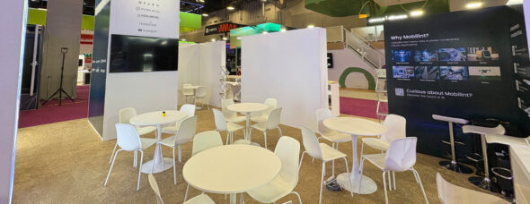 Modern tech exhibit with AI displays and meeting tables