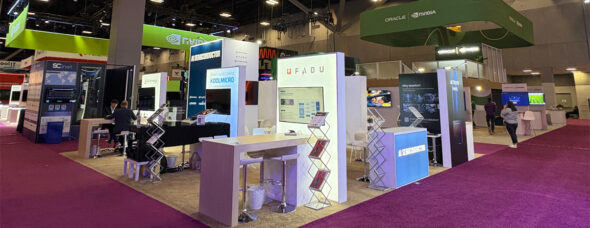 International tech trade show booth with overhead hanging signs