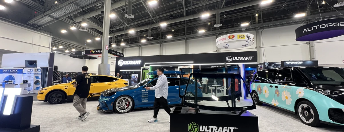 Trade show booth beneath bold overhead signage