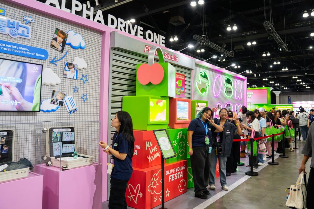 ALPHA DRIVE ONE photo studio activation with green stacked box display at Olive Young Festa KCON LA