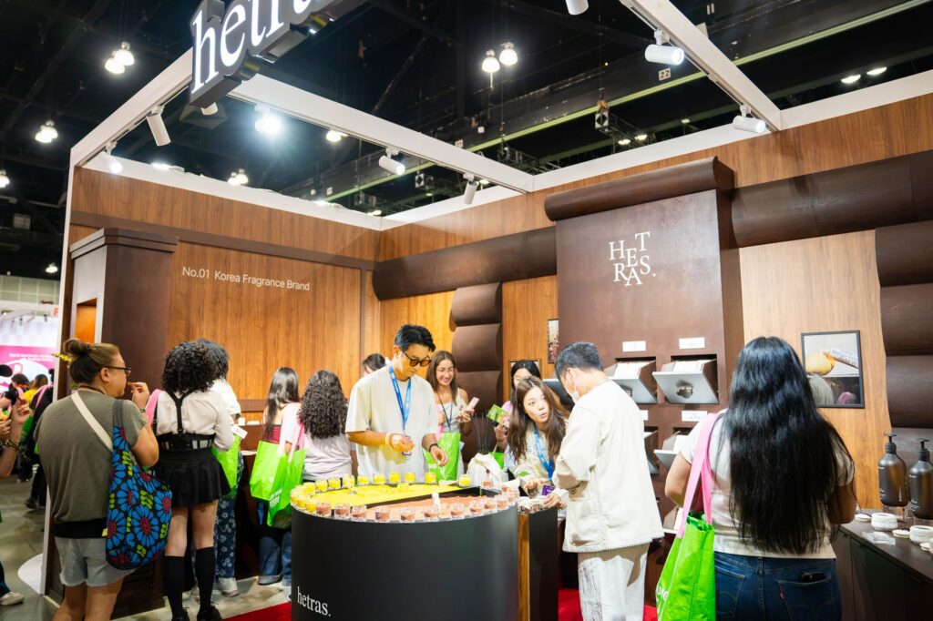 Hetras Korean fragrance booth with walnut wood finish and scent sampling table at Olive Young Festa