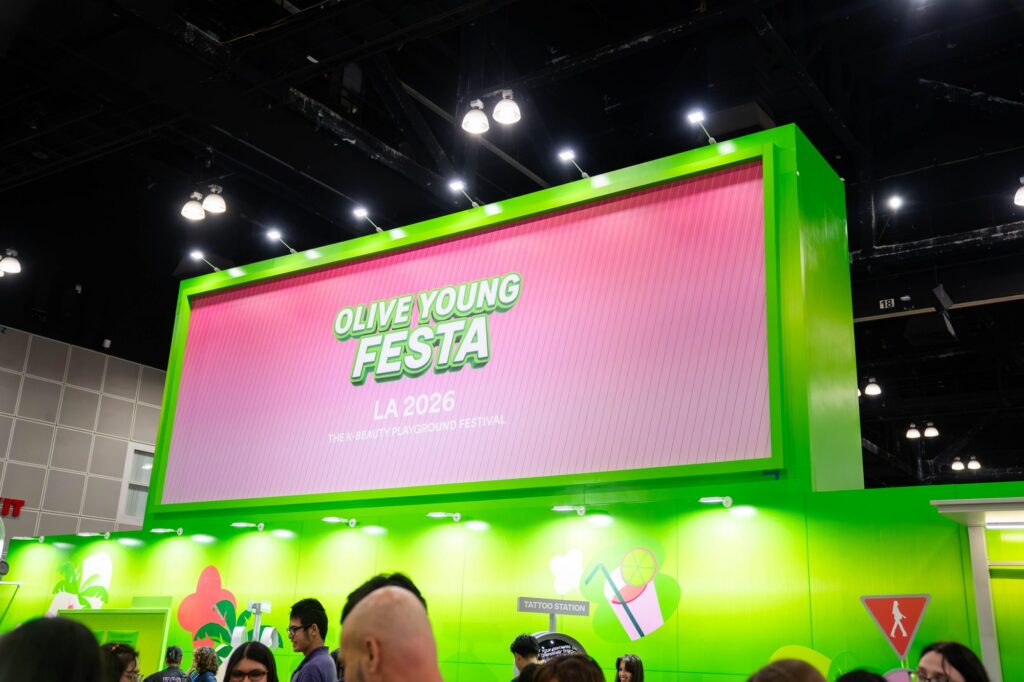 Olive Young Festa LA 2026 illuminated tower sign with green gradient panels