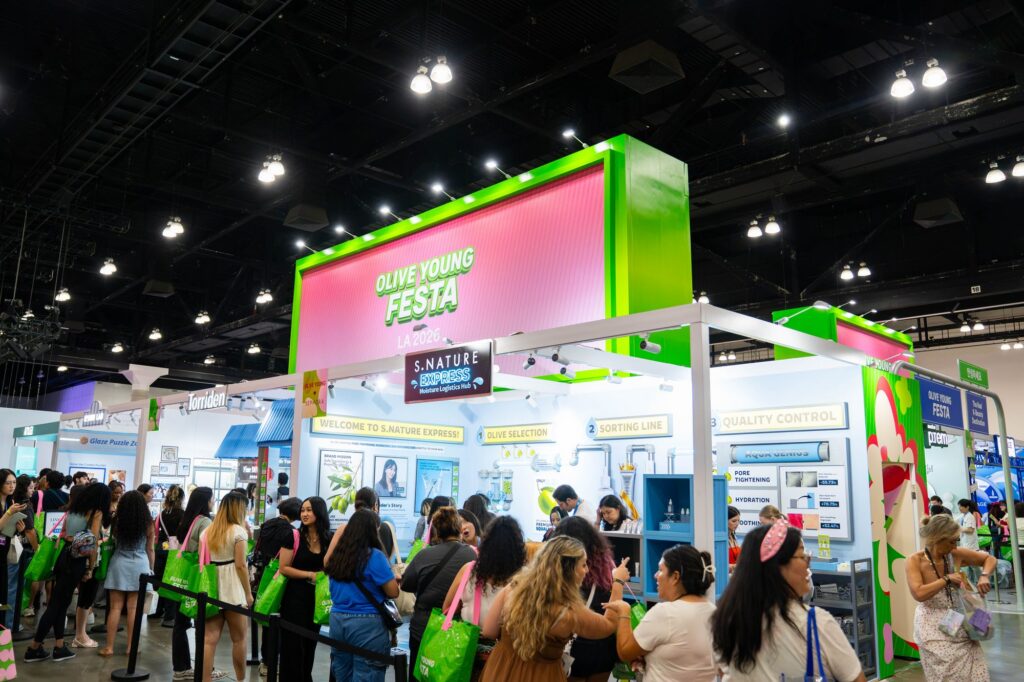 S.Nature Express brand booth with sorting line graphics under the Olive Young Festa tower sign