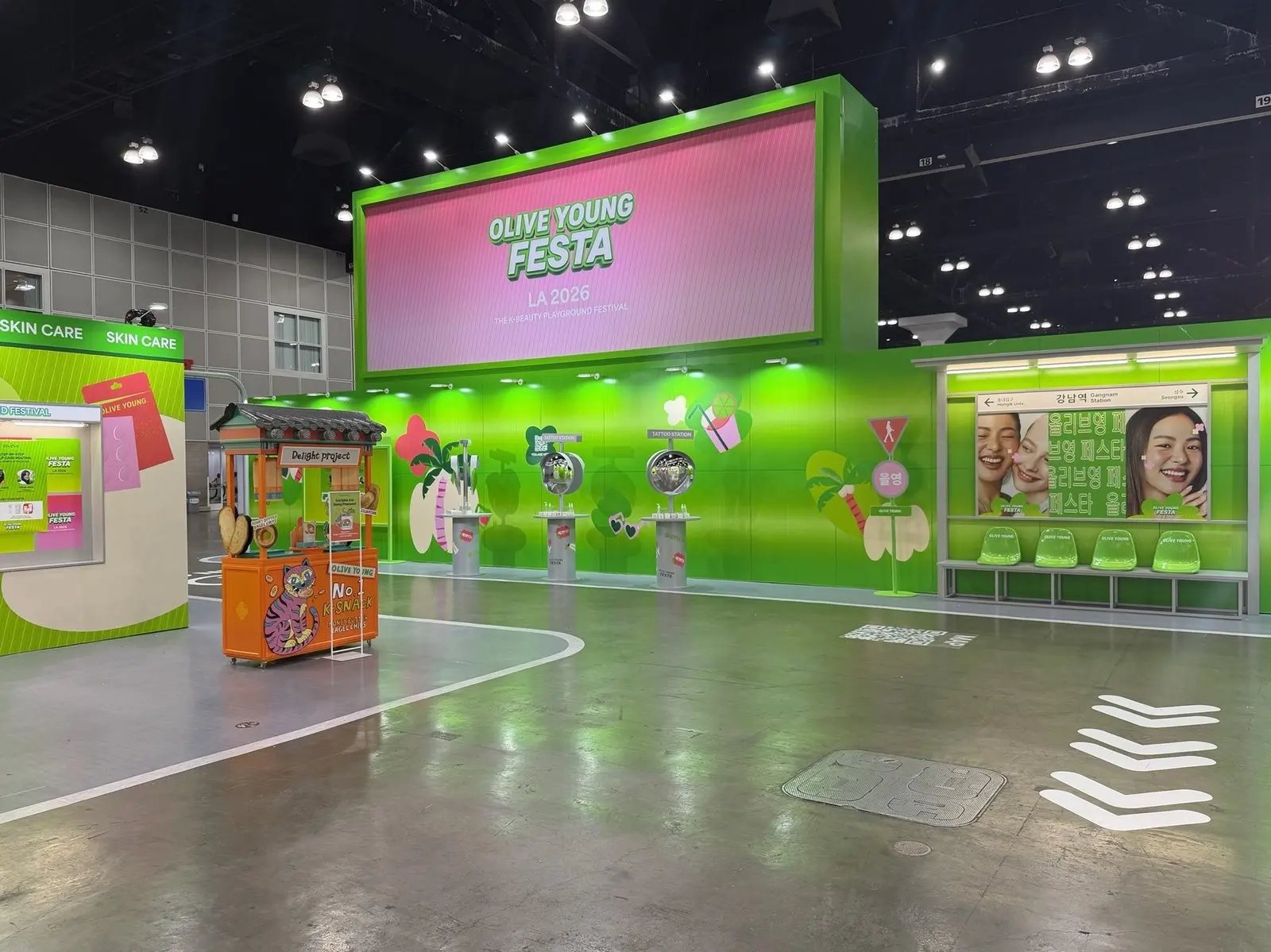 Olive Young Festa playground zone with LED screen and street-cart set at KCON LA 2026