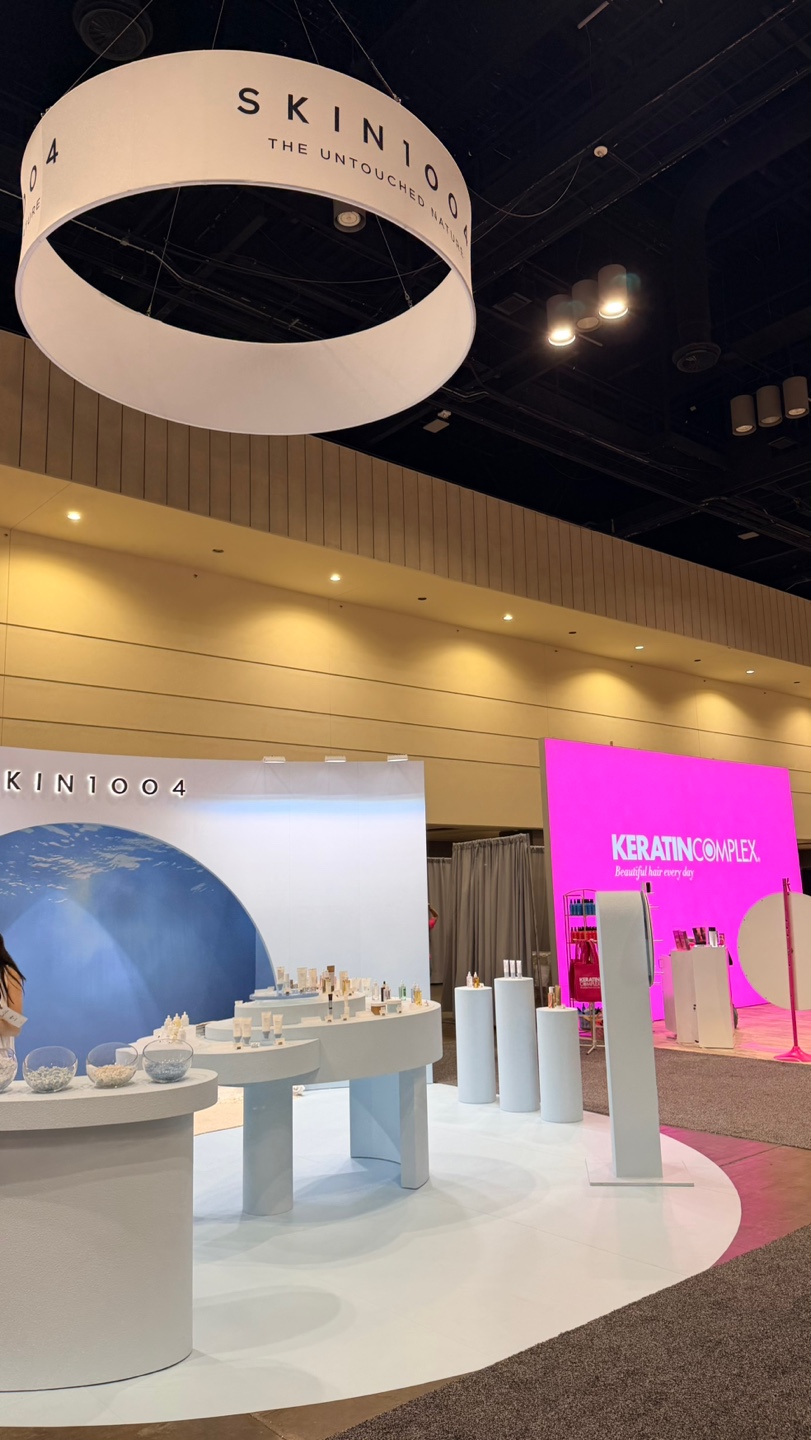 Suspended circular SKIN1004 ring sign above the show floor