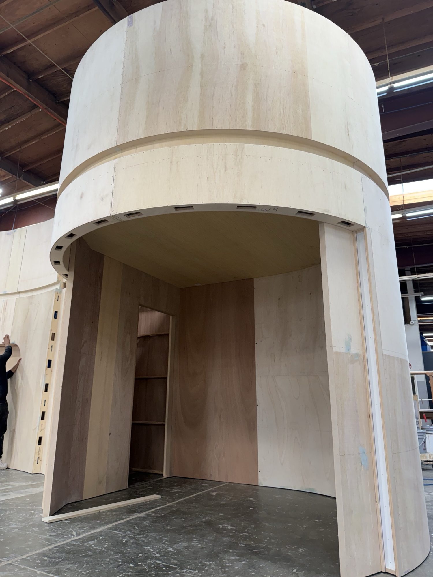 Round plywood tower with a built-in storage room for the Medicube booth
