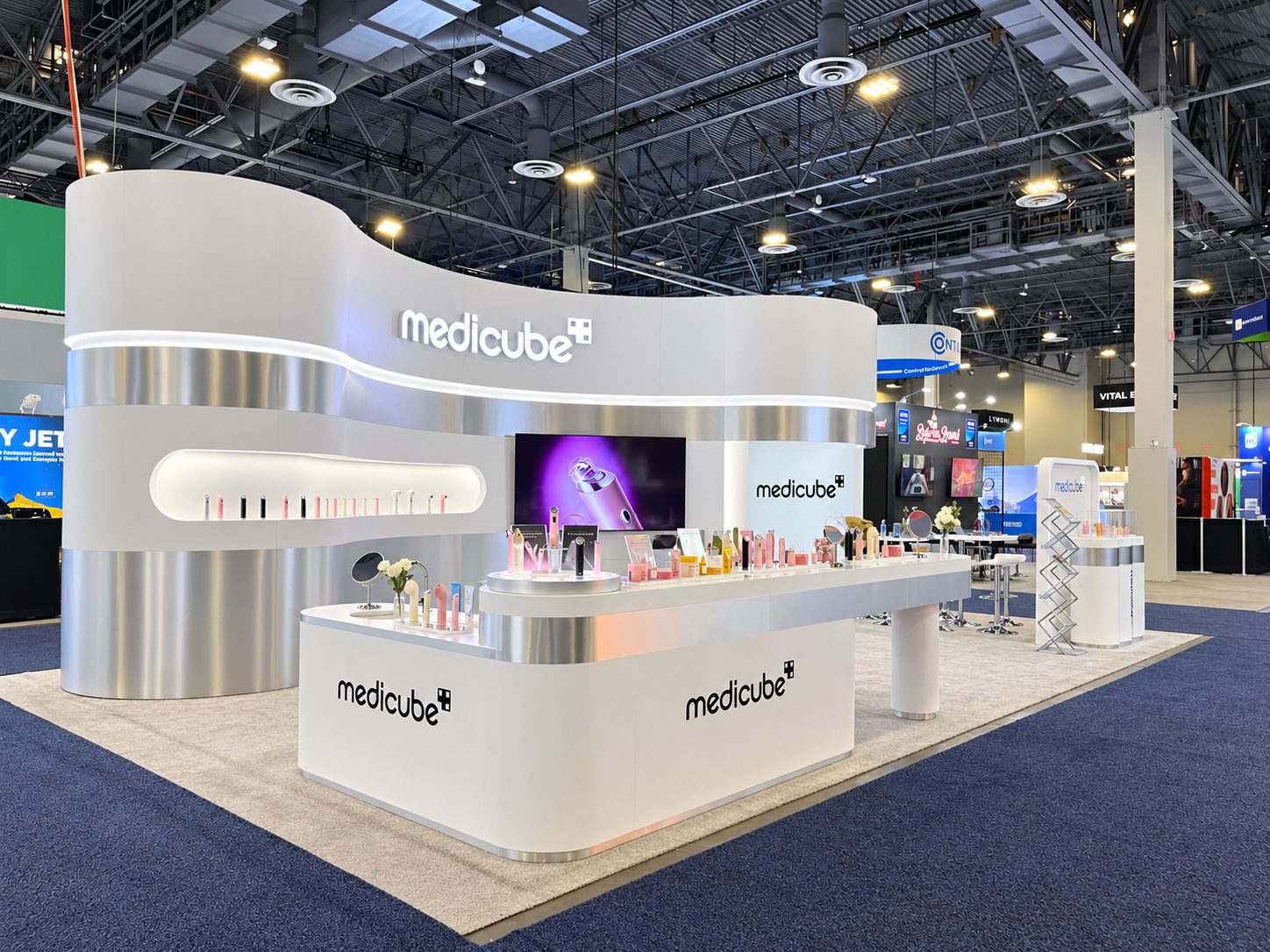 Medicube booth product display wall with LED-lit niche at CES 2026