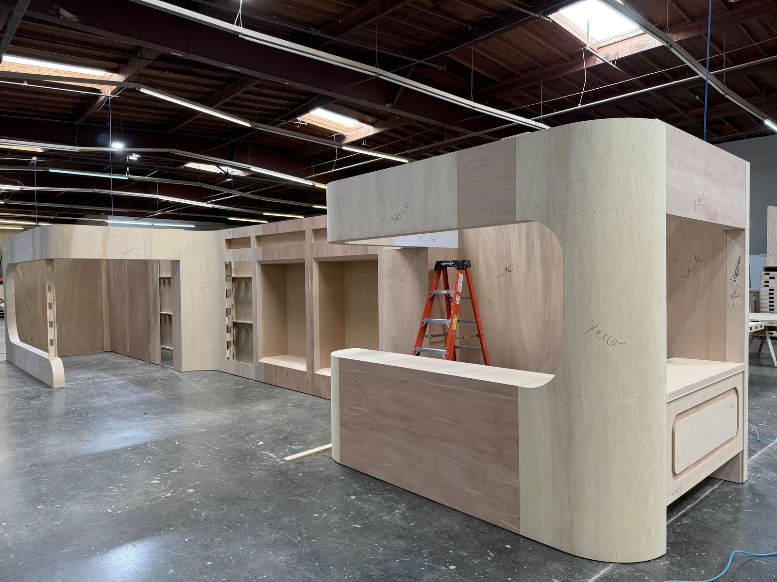 Plywood smoothie-cart counter and rounded arch frame during carpentry