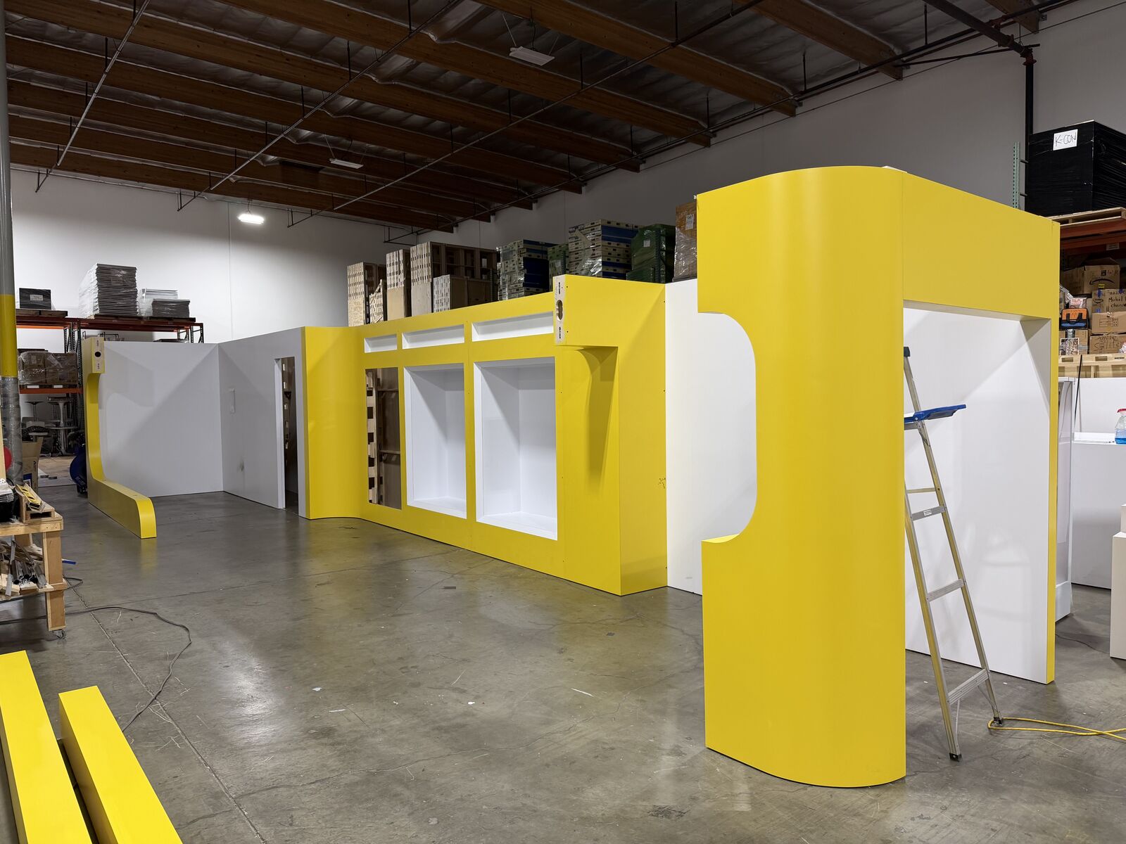 Eqqualberry display wall finished in yellow and white, assembled in the Beaver XP warehouse
